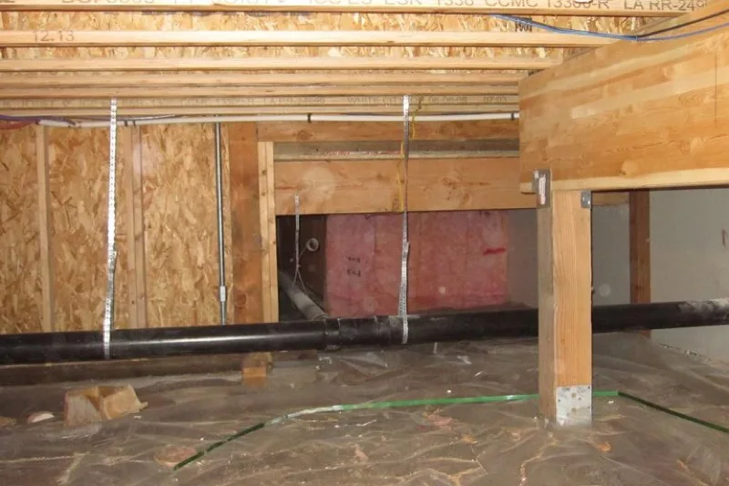 dry organized crawlspace with insulation plumbing